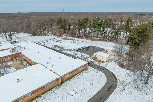 The playground and basketball court is behind the Tracey's Elementary School building.