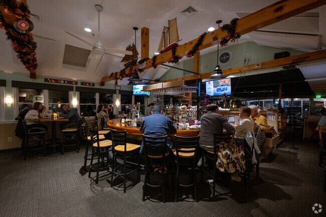 Patrons gather inside The Lobster Pot, a cozy Provincetown bar, for evening drinks.