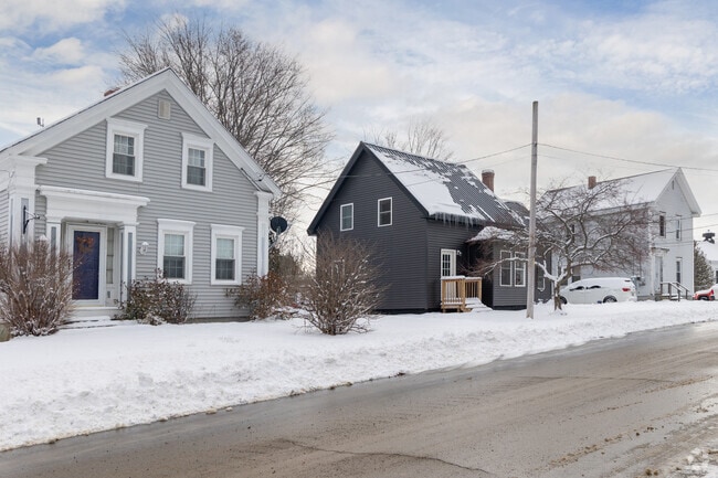 A row of classic homes lines a snow-covered Orrington street.