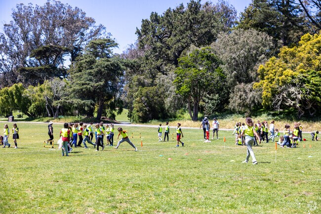 Kids kick around a soccer ball in nearby Golden Gate Park, adjacent to Lone Mountain