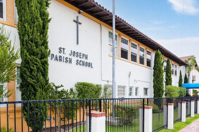 St. Joseph Elementary School in Hawthorne, CA has well kept trees and grass lining the school.