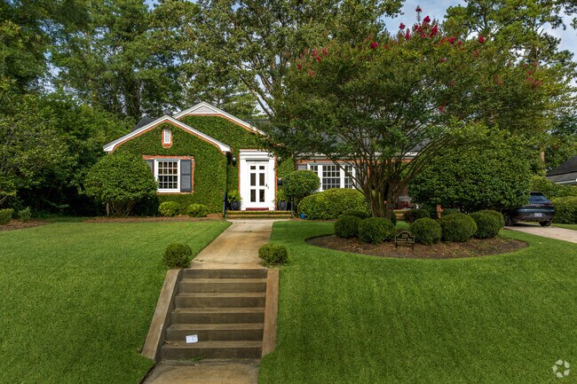 A brick ranch home in Forest Hills North is accented with natural ivy.