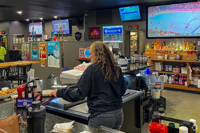 Over 30 plasma TVs and 5 huge projection screens playing sports at the Erie Pub.