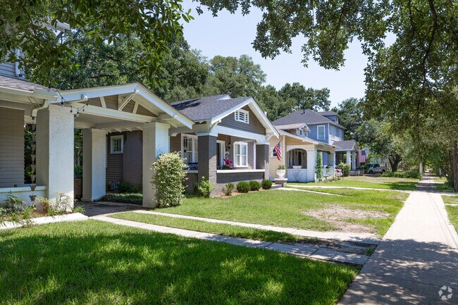 Craftsman-style homes line a quiet, sidewalk-framed street in historic Lyons Park.
