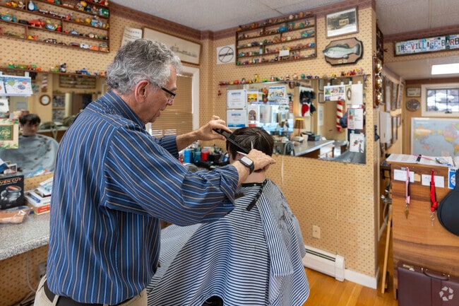A person gets their hair cut at The Village Barber in Weston.