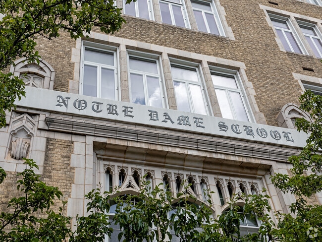 Notre Dame School sign has a unique font to display the name in West Village.