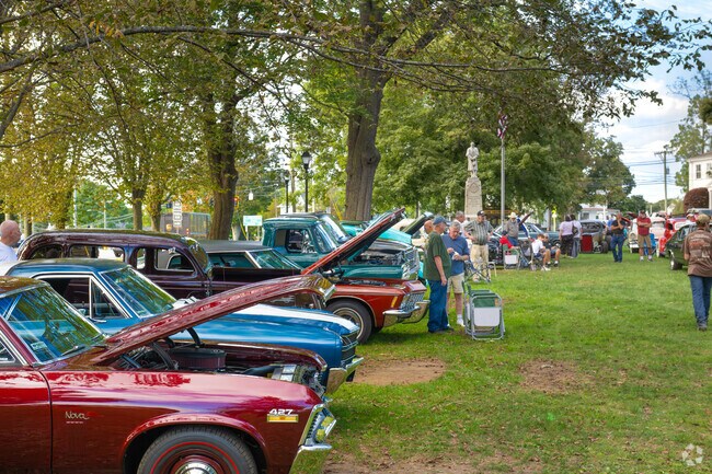 Classic car aficionados gather around Colchester’s town green for a summer event.