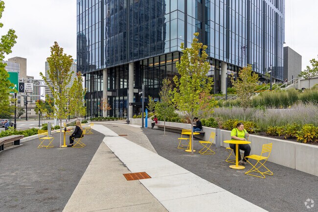 People enjoy their lunch break outside of the FNB Financial Center in Crawford-Roberts.