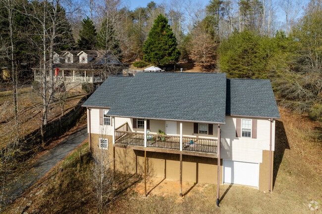 Cape Cod style houses surrounded by trees can also be found in Dacusville.