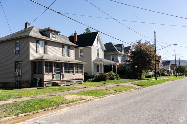 An American Foursquare and a farmhouse are set on small lots in this section of Porter.