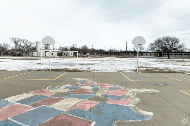 Woodman Elementary School has an outdoor basketball court.
