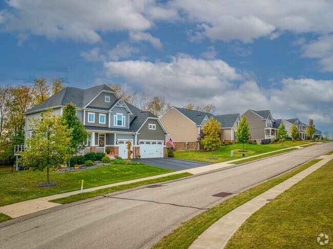 A large folk victorian home sits on a family street in Findlay township.
