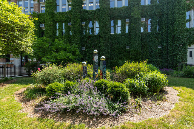 Ivy covered wall and green garden Alcott College Prep East Campus, Chicago Illinois.