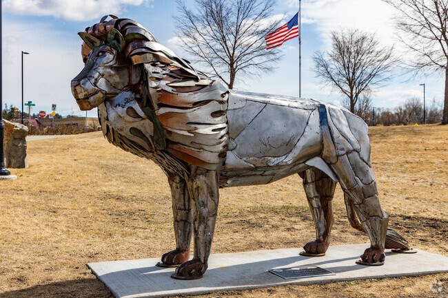 A metal lion sculpture welcomes visitors to Lions Park in downtown Sauk Rapids.