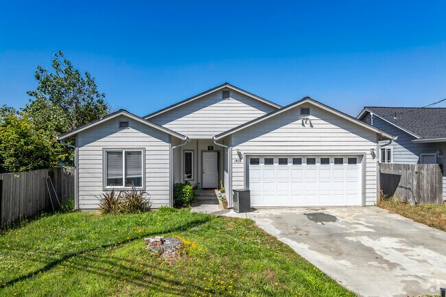 This newer ranch-style home in Manila has an inset front door and 2-car garage.
