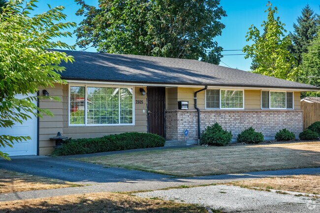 A ranch style home surrounded by thick evergreen trees can be found on a quiet Riverview street.