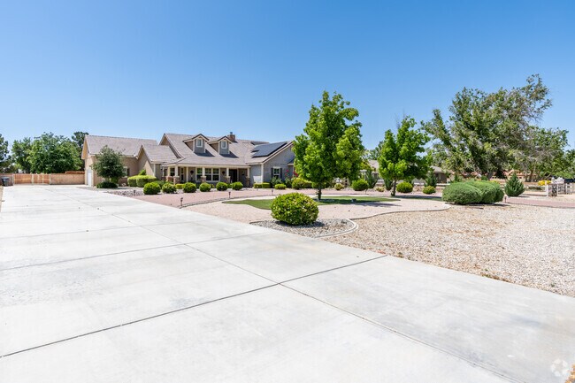 This ranch-style home welcomes you with its manicured front yard and large driveway.
