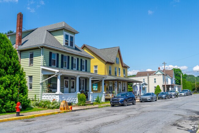 Traditional American Foursquare homes face the sidewalk in Bowmanstown’s residential area.