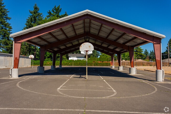 Covered and uncovered basketball courts behind the Menlo Park School.