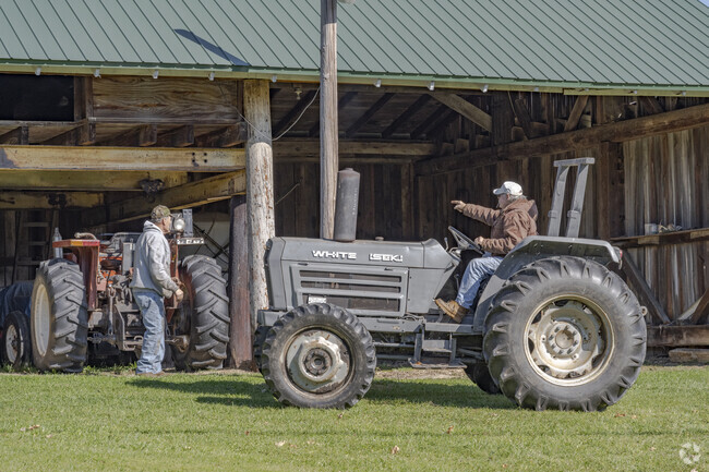 A farmer in Susquehanna gives direction to his lead worker.