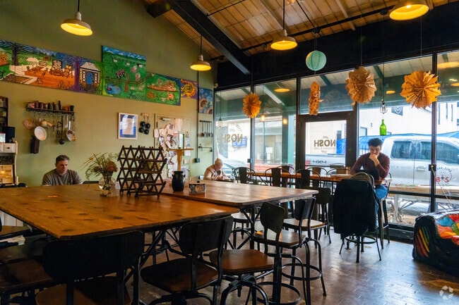 People hang out in Nosh's colorful dining area in Metro City.