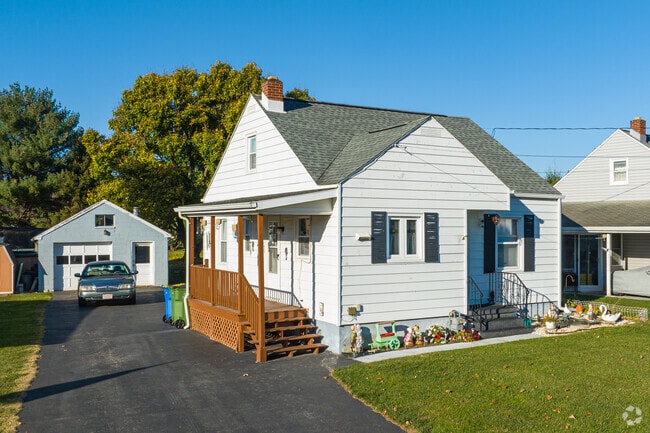 A Bungalow style home in Emigsville with an attached driveway and detached garage.