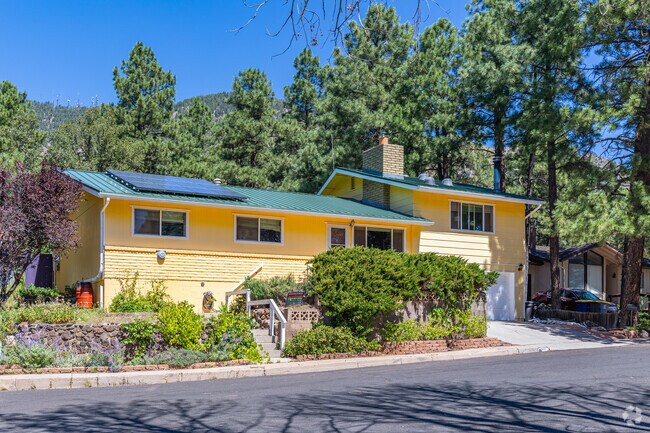Shadow Mountain yards are often planted with flower beds and tall stands of ponderosa pines.