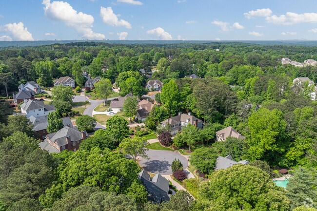 The Nesbit Lakes community is surrounded by lush greenery and spacious homes nestled among the trees.