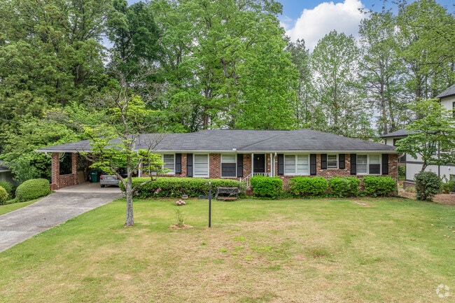 A classic single-story ranch home in Mountaire Springs with a charming front porch and mature trees offers timeless suburban appeal.