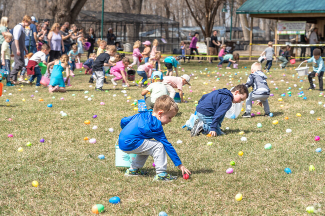 Kids run and gather colorful eggs during the Easter Egg Hunt at the Dakota Zoo.