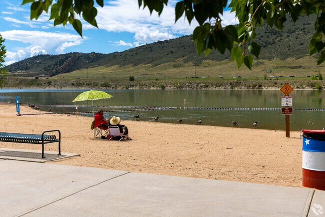 Relax on the beach at Bear Creek Lake Park near Red Rocks Ranch.