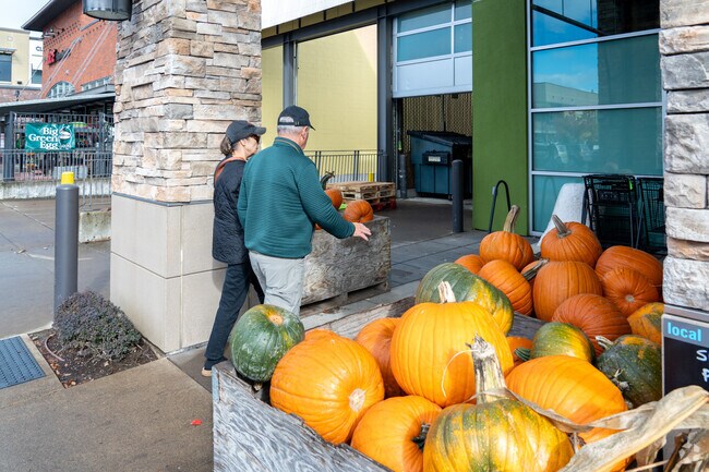 A couple shops for pumpkins at their local New Seasons.