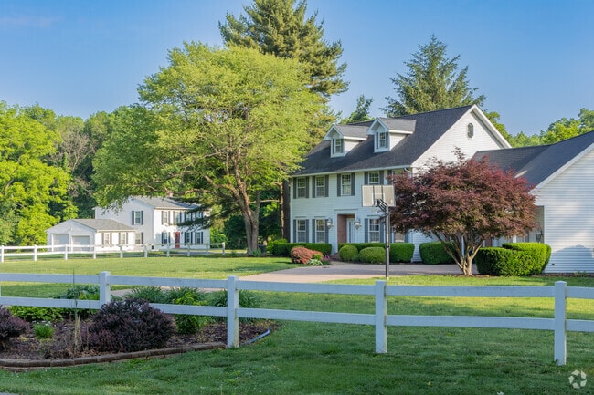 Tecumseh homes often have fenced in yards with multiple car garages on large lots.