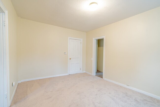 Living Room facing door to hall and door to Master Bedroom via small walk through small Hall