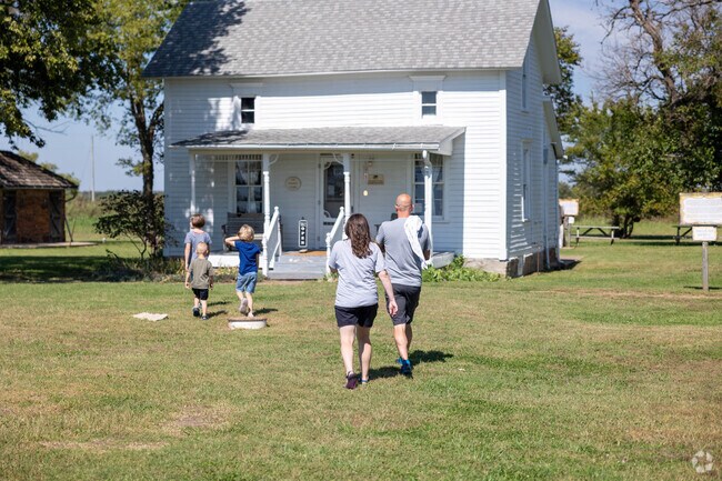 Visitors explore the historic Ingalls home at the Little House on the Prairie Museum.
