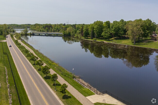 Moores River Drive runs alongside the Grand River in Averill Woods, Lansing, offering scenic views for residents and visitors.