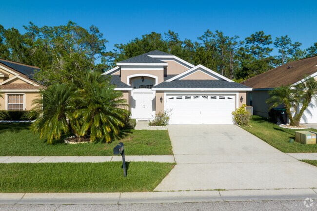 Tropical plants adorn the front lawns of most homes in Cypress Springs.