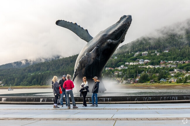 A life-sized whale sculpture emerging from an infinity pool is situated near North Douglas.