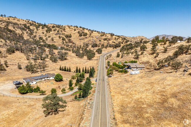 Yokuts Valley’s rural roads stretch through dry hills dotted with homes and native trees.