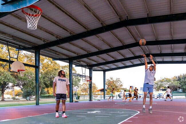 Friends play basketball at the covered courts at Stafford City Park near Fifth Street.