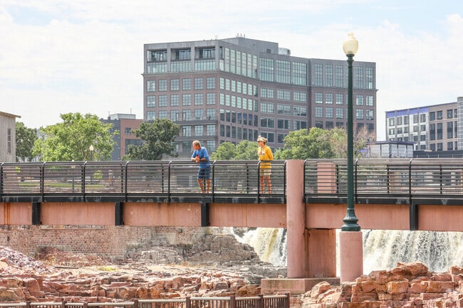 Enjoy scenic views of the waterfall framed by downtown at Falls Park near Norton Tracts.