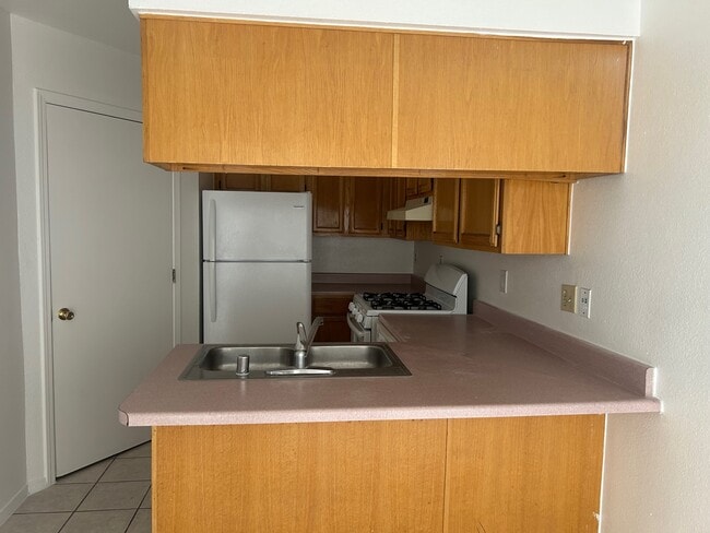 Kitchen with refrigerator, stove and dish washer. Hookups for laundry