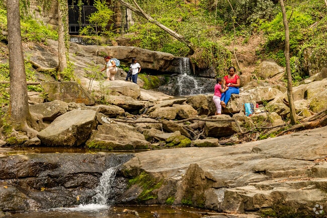 Cascade Springs Nature Preserve features a small waterfall with rocks, a popular relaxing spot.