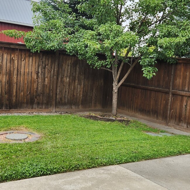 Private back yard with patio, hobby shed, flower beds