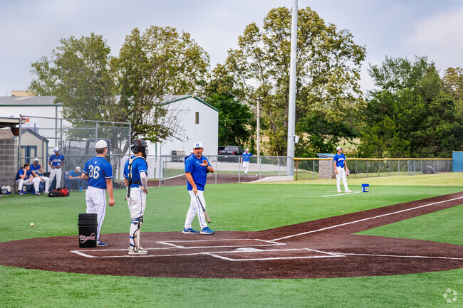 The Harrison High School baseball team prepares for a game at Equity Bank Sports Complex.