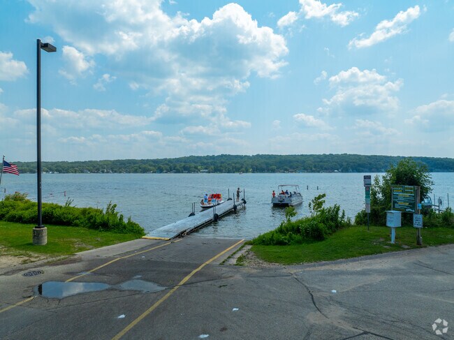 Paved ramp and dock at Mars Resort on Lake Como, with boats and people enjoying the water.