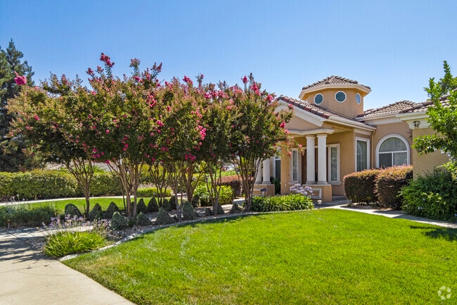 Colorful trees lead to a Spanish style home in Del Rio.