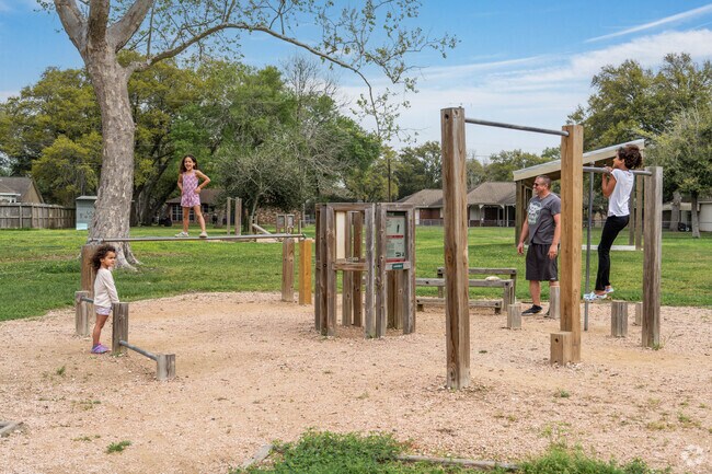 A family enjoys a workout at the public equipment at Tambrella Park in Santa Fe.