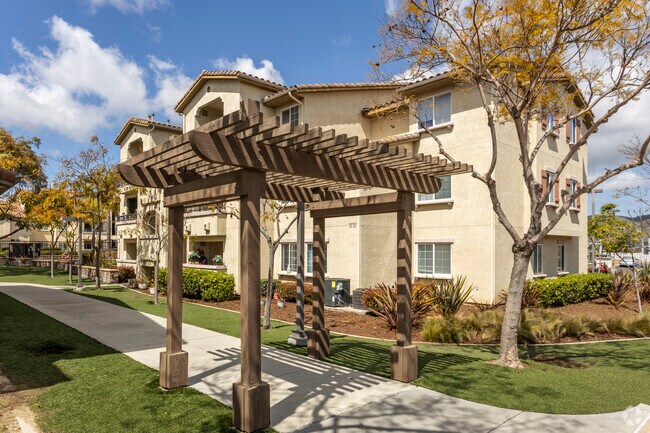 Three Story Multifamily Building next to Mediterranean Style Single Family Home in Del Sur.