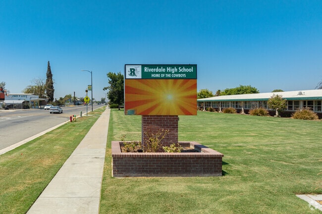 A large marquee at the entrance to Riverdale High School informs parents of events.